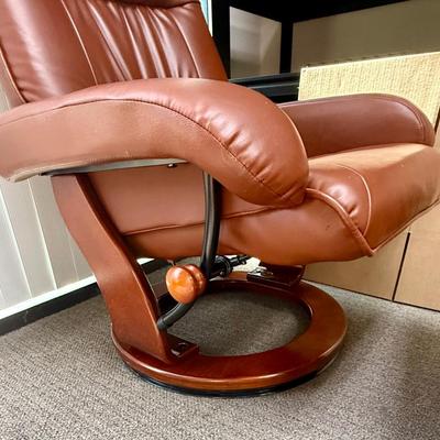 Sale Photo Thumbnail #594: Recliner chair and matching ottoman.  Good overall condition, some tiny spots in a few places on the material, not noticeable from a distance. Product details:
Color: Caramel Brown
Item dimensions (L x W x H): 42 x 30 x 40 inches
Material: Faux Leather, W
