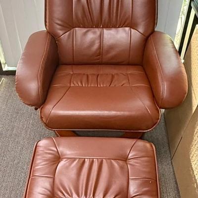 Sale Photo Thumbnail #592: Recliner chair and matching ottoman.  Good overall condition, some tiny spots in a few places on the material, not noticeable from a distance. Product details:
Color: Caramel Brown
Item dimensions (L x W x H): 42 x 30 x 40 inches
Material: Faux Leather, W