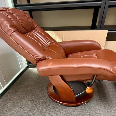 Sale Photo Thumbnail #586: Recliner chair and matching ottoman.  Good overall condition, some tiny spots in a few places on the material, not noticeable from a distance. Product details:
Color: Caramel Brown
Item dimensions (L x W x H): 42 x 30 x 40 inches
Material: Faux Leather, W