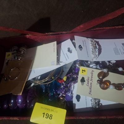 Sale Photo Thumbnail #376: this is a misc bundle of jewelry in the box it may be tangled or earrings may be mismatched.  It looks to be dollar store items