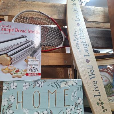 Sale Photo Thumbnail #476: bread tubes, tennis racket, framed winter picture, wall sign and storage box labed "home"