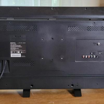 LOT 11B: Sony 32" TV and Remote with Glass Door Two Shelf Stand on Wheels