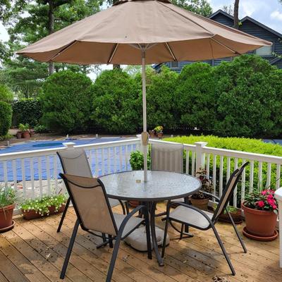 LOT 155P: Glass Round Patio Table with Four Chairs and Unfolding Umbrella