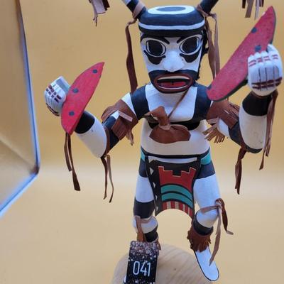 Sale Photo Thumbnail #299: Artist = Largo     Beautiful Clown Kachina with leather accents.
14.5 inches tall.  Retails at $350 to  $900
Noted Largo artists include Francis Largo, Gary Largo, N. Largo and M.E. Largo
The Clown Kachina is a significant figure in Native American cultur