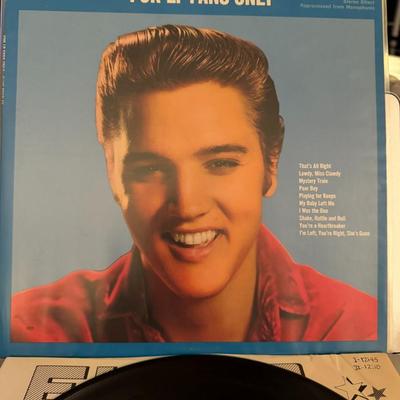 Sale Photo Thumbnail #108: Elvis Presley's "For LP Fans Only" [1]. The album, released by RCA Victor, has the catalog number LSP-1990(e) [1]. It displays a blue background and a smiling Elvis Presley wearing a red shirt [1].
The tracklist on the cover includes:
"That's All Right"
"