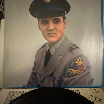 Sale Photo Thumbnail #110: Elvis Presley's "For LP Fans Only" [1]. The album, released by RCA Victor, has the catalog number LSP-1990(e) [1]. It displays a blue background and a smiling Elvis Presley wearing a red shirt [1].
The tracklist on the cover includes:
"That's All Right"
"