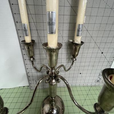 Sale Photo Thumbnail #83: The candelabra includes five tall ivory taper candles, each still wrapped in plastic with manufacturer labels intact.
