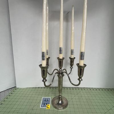 Sale Photo Thumbnail #81: The candelabra includes five tall ivory taper candles, each still wrapped in plastic with manufacturer labels intact.