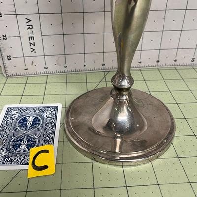 Sale Photo Thumbnail #84: The candelabra includes five tall ivory taper candles, each still wrapped in plastic with manufacturer labels intact.
