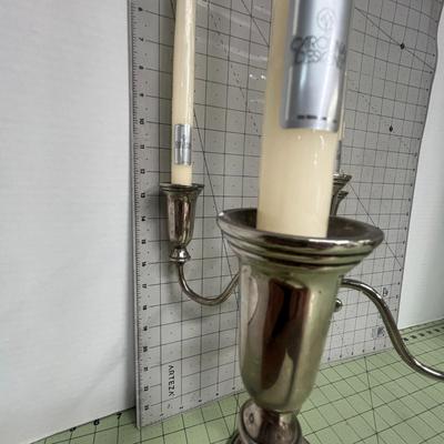 Sale Photo Thumbnail #82: The candelabra includes five tall ivory taper candles, each still wrapped in plastic with manufacturer labels intact.