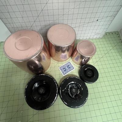 Sale Photo Thumbnail #94: Set of 3 copper-tone canister with glossy black plastic lids.