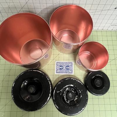 Sale Photo Thumbnail #92: Set of 3 copper-tone canister with glossy black plastic lids.