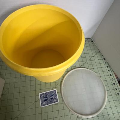 Sale Photo Thumbnail #193: Round Yellow Storage bin and a square lid with an integrated carry handle.