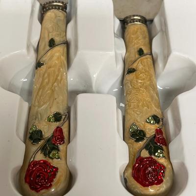 Sale Photo Thumbnail #299: Elegant Floral Handles Embellished with Red Rose Accents.