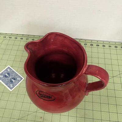 Sale Photo Thumbnail #398: Red ceramic pitcher with classic round-bellied shape.