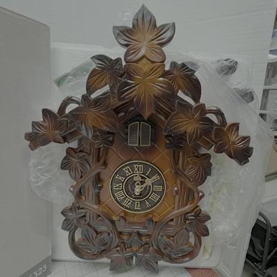 Sale Photo Thumbnail #560: Classic Black Forest-style leaf carvings and Cuckoo doors above the dial.