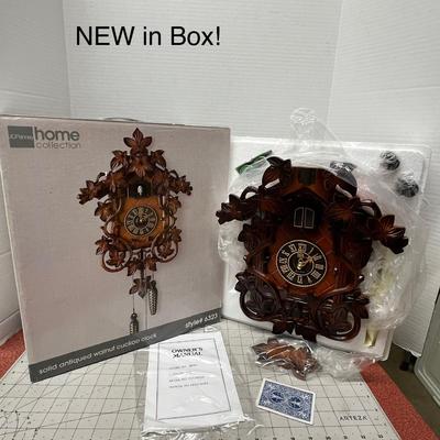 Sale Photo Thumbnail #559: Classic Black Forest-style leaf carvings and Cuckoo doors above the dial.