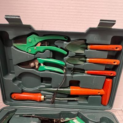 Sale Photo Thumbnail #890: Complete garden tool kit with wooden handles and green case.