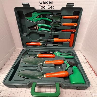 Sale Photo Thumbnail #888: Complete garden tool kit with wooden handles and green case.