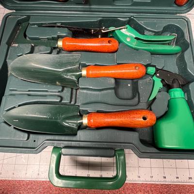 Sale Photo Thumbnail #889: Complete garden tool kit with wooden handles and green case.