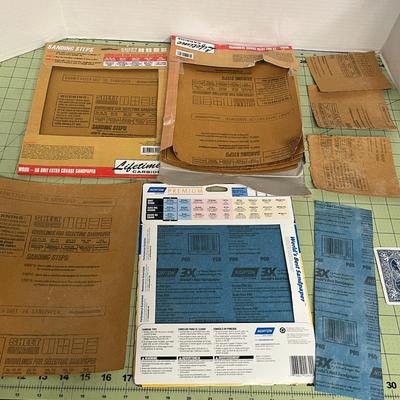 Sale Photo Thumbnail #895: Complete painting kit with sandpaper, rollers, scrapers, and lacquer thinner.