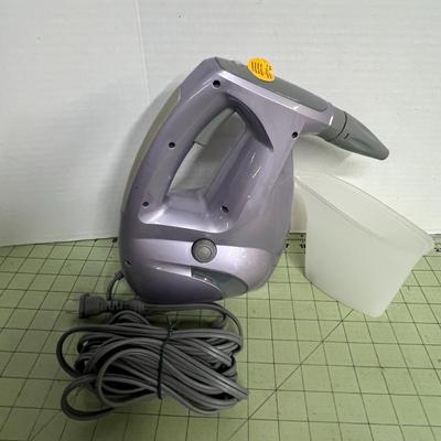 Sale Photo Thumbnail #960: Open box, unused handheld steamer cleans and sanitizes surfaces effectively.