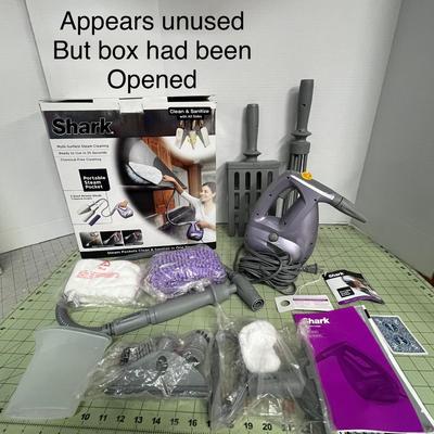 Sale Photo Thumbnail #957: Open box, unused handheld steamer cleans and sanitizes surfaces effectively.