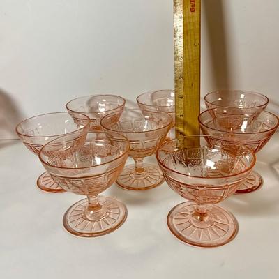 LOT 69: Large Selection of Pink Depression Glass Including Raised Platters, Covered Bowl, Candy Dish with Lid, Stemmed Glassed and Tooth...