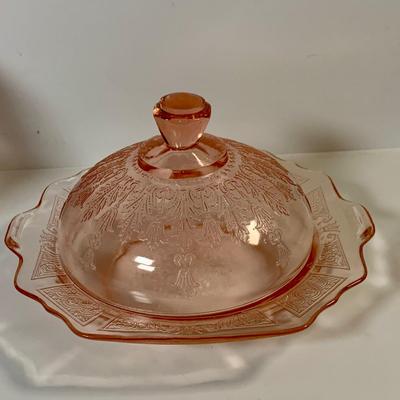 LOT 69: Large Selection of Pink Depression Glass Including Raised Platters, Covered Bowl, Candy Dish with Lid, Stemmed Glassed and Tooth...