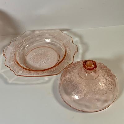 LOT 69: Large Selection of Pink Depression Glass Including Raised Platters, Covered Bowl, Candy Dish with Lid, Stemmed Glassed and Tooth...