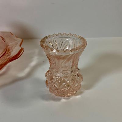LOT 69: Large Selection of Pink Depression Glass Including Raised Platters, Covered Bowl, Candy Dish with Lid, Stemmed Glassed and Tooth...