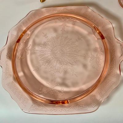 LOT 69: Large Selection of Pink Depression Glass Including Raised Platters, Covered Bowl, Candy Dish with Lid, Stemmed Glassed and Tooth...