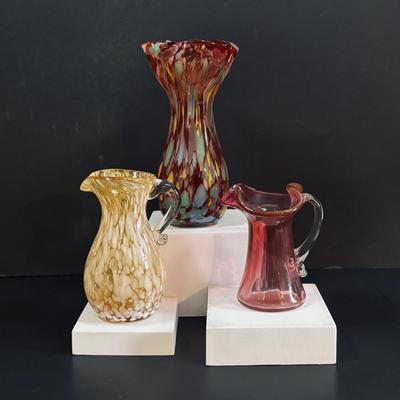 LOT 115: Beautiful Glass Collection: Amber/Gold Handblown Pitcher, Multi Color Art Glass Vase (orange, red, blue) and Cranberry Pitcher