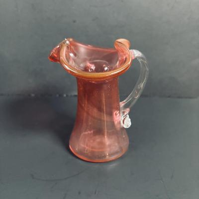 LOT 115: Beautiful Glass Collection: Amber/Gold Handblown Pitcher, Multi Color Art Glass Vase (orange, red, blue) and Cranberry Pitcher