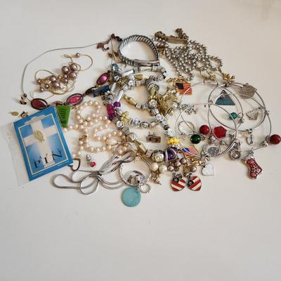 Sale Photo Thumbnail #211: This auction lot is for a Bag of Costume Jewelry.  This is a real mix of items found in a dresser drawer.  There are necklaces, earrings, pins, rings and other miscellaneous items - please see pictures.  Grab this deal quick.