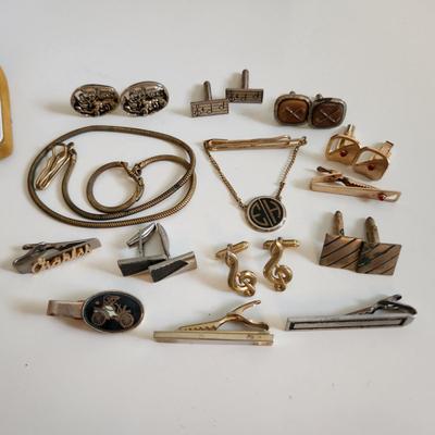 Sale Photo Thumbnail #215: This auction lot is for a Swank Box of Men's Jewelry. This item has all types of men's jewelry.  There is a brass railroad-type watch fog, several tie tack, pins and bars, a nice collection of cuff links - some with trains and other with musical motifs. I