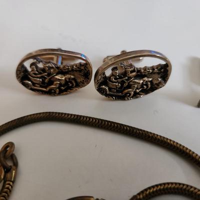 Sale Photo Thumbnail #218: This auction lot is for a Swank Box of Men's Jewelry. This item has all types of men's jewelry.  There is a brass railroad-type watch fog, several tie tack, pins and bars, a nice collection of cuff links - some with trains and other with musical motifs. I