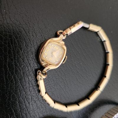 Sale Photo Thumbnail #226: This auction lot is for Three Ladies Watches.  From our latest estate there is an everyday wear Timex - appears to only need a new battery to be ready to wear.  There is an old Benrus watch marked Swiss made and show 10K RPG on the verso.  The third watch
