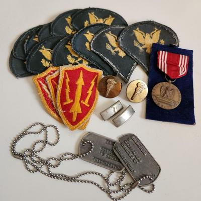 Sale Photo Thumbnail #237: This auction lot is for a gathering of Military Items. This offering contains about ten SP4 patches, three patches from the WW2 US Army Air Defense Command, a pair of Lieutenant's bars, two brass ROTC Torch emblems, a good conduct ribbon and a set of dog 