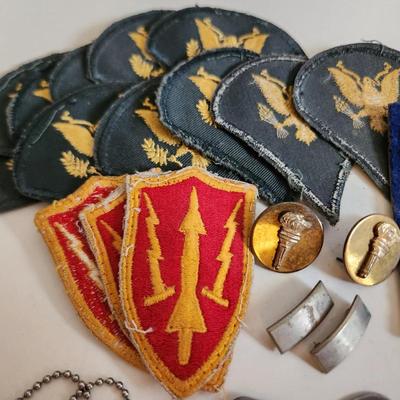 Sale Photo Thumbnail #241: This auction lot is for a gathering of Military Items. This offering contains about ten SP4 patches, three patches from the WW2 US Army Air Defense Command, a pair of Lieutenant's bars, two brass ROTC Torch emblems, a good conduct ribbon and a set of dog 