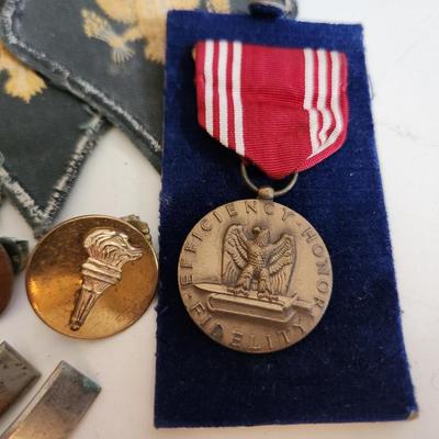 Sale Photo Thumbnail #239: This auction lot is for a gathering of Military Items. This offering contains about ten SP4 patches, three patches from the WW2 US Army Air Defense Command, a pair of Lieutenant's bars, two brass ROTC Torch emblems, a good conduct ribbon and a set of dog 
