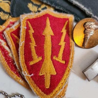 Sale Photo Thumbnail #242: This auction lot is for a gathering of Military Items. This offering contains about ten SP4 patches, three patches from the WW2 US Army Air Defense Command, a pair of Lieutenant's bars, two brass ROTC Torch emblems, a good conduct ribbon and a set of dog 