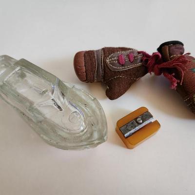 Sale Photo Thumbnail #248: This fun little lot is for a Vintage Trio of Memories.  There is a glass boat candy container, a pair of souvenir miniature boxing gloves from a visit to St. Augustine, Florida and a really cool celluloid pencil sharpener from another era.  Where you gonn