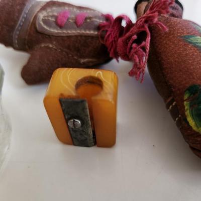 Sale Photo Thumbnail #251: This fun little lot is for a Vintage Trio of Memories.  There is a glass boat candy container, a pair of souvenir miniature boxing gloves from a visit to St. Augustine, Florida and a really cool celluloid pencil sharpener from another era.  Where you gonn