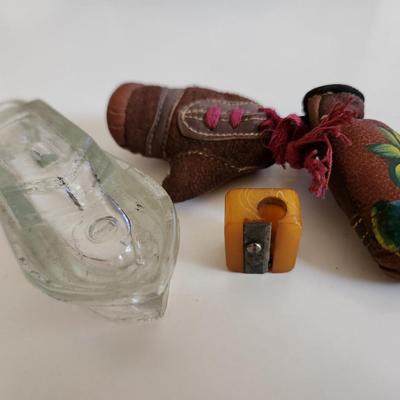 Sale Photo Thumbnail #250: This fun little lot is for a Vintage Trio of Memories.  There is a glass boat candy container, a pair of souvenir miniature boxing gloves from a visit to St. Augustine, Florida and a really cool celluloid pencil sharpener from another era.  Where you gonn