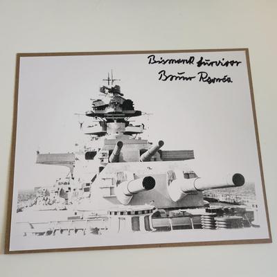 Sale Photo Thumbnail #291: This auction lot is for a photograph of the German Battleship Bismarck with an Autograph of Bismarck Battleship Survivor Bruno Rzonca.  Of the 2,200 people on that ship only 114 survived it's sinking.  Mr. Rzonca was the only one of those survivors who li