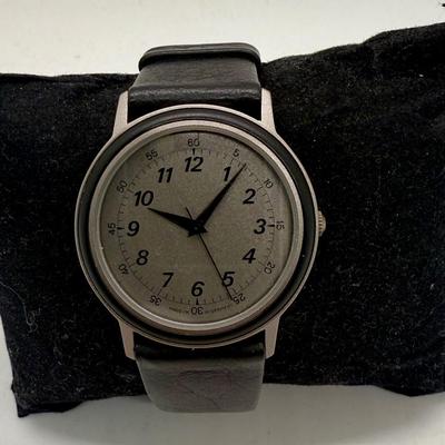 Sale Photo Thumbnail #149: Made in West Germany. Water resistant to 3 ATM. Black leather band, watch face is approx. 32mm. Good condition, needs a new battery.