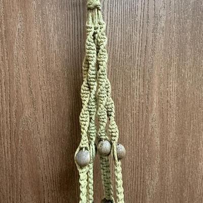 Sale Photo Thumbnail #132: Green macramé material and wood beads. In good condition.