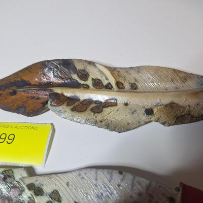 Sale Photo Thumbnail #7: lot of two, they are the same size althought he angle of the photo makes one look larger than the other.  One has a small chip or it is believed to be a chip as the the part of the feather there is not pointed.  These are delicate items, the colors are sl