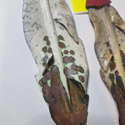 Sale Photo Thumbnail #12: lot of two, they are the same size althought he angle of the photo makes one look larger than the other.  One has a small chip or it is believed to be a chip as the the part of the feather there is not pointed.  These are delicate items, the colors are sl